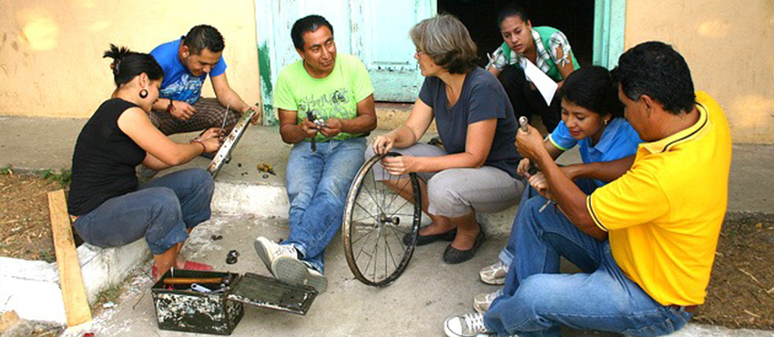 MIT D-Lab Founding Director Amy Smith (third from right) with inventor and Bici-Tec Founder Carlos Marroquin (third from left), working with members of a community in El Salvador.