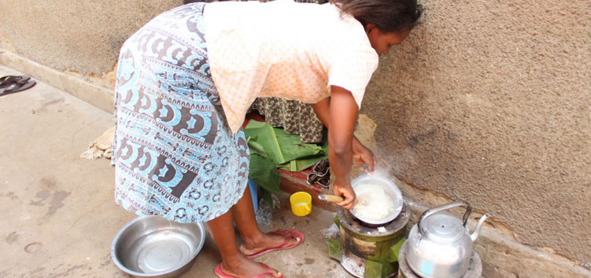 A community member cooking on her Makaa stove just after the team installed a sensor on it.