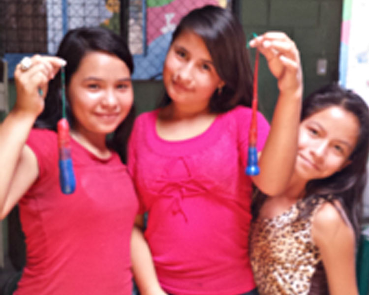 Girls from Barefoot Angels showing the candles they made.