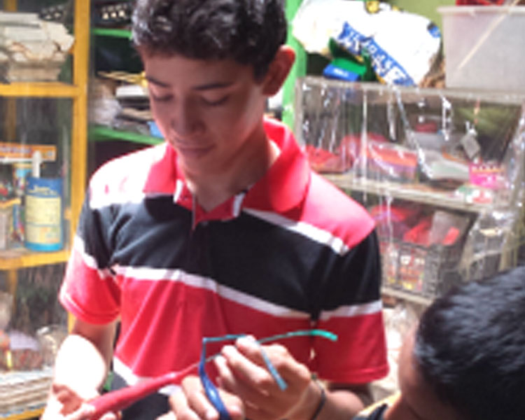 Boys from Barefoot Angels inspecting their hand-made candles.