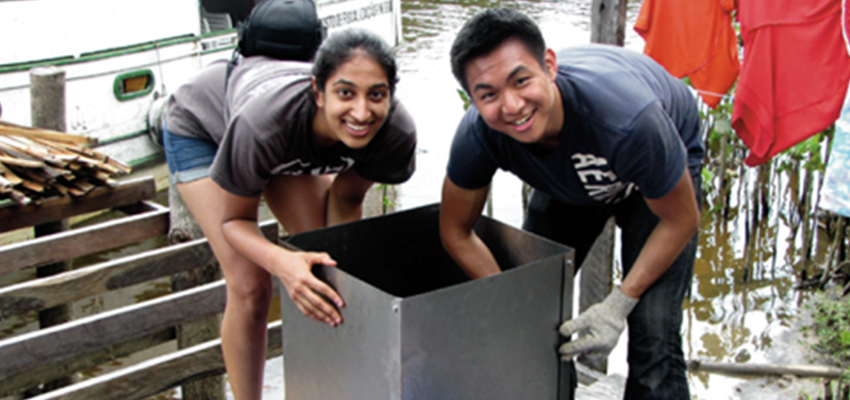 D-Lab: Energy I students assembling a kiln to burn acai pits in Brazil, 2014.