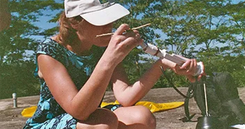 Smith designs a chlorination dispenser for a water symptom in Honduras, improvising with the parts of a toilet tank. Photo: Courtesy Amy Smith