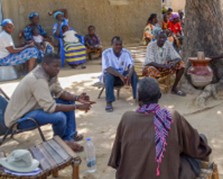 Mercy Corps' Sory Mariko discussing the energy needs with community leaders in the village of Tiby, Mali.