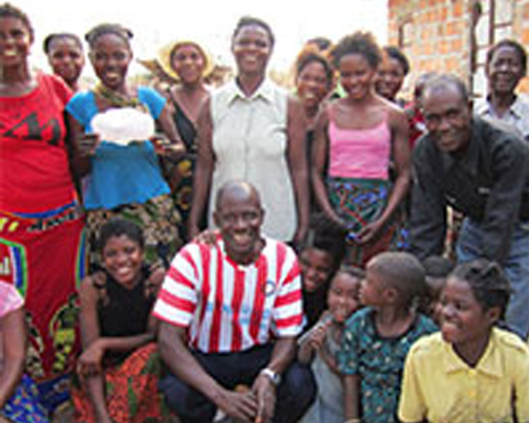 Martin (bottom center) with his team and community members in Kamphelo, where the community and team worked together to create a disposable sanitary pad prototype.