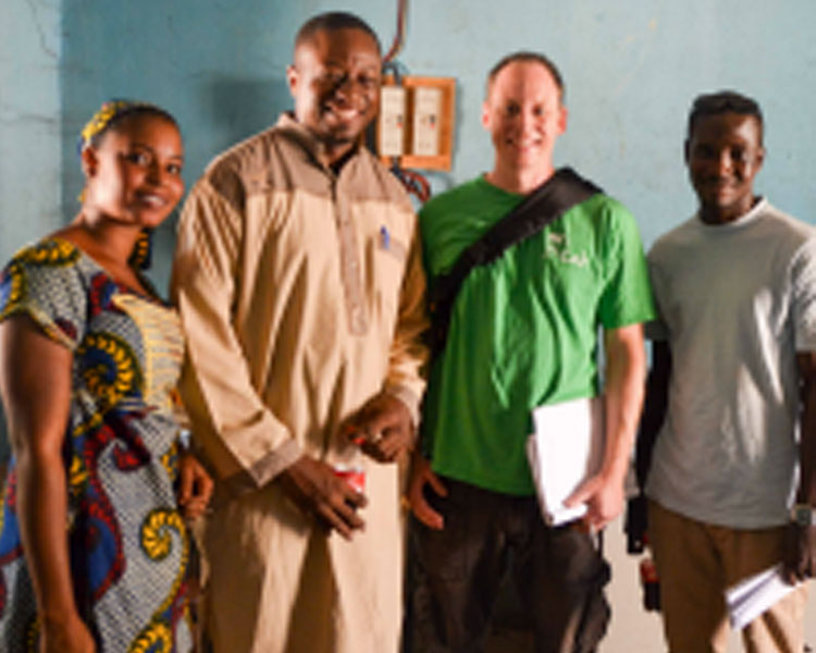 (l-r) A woman who works at a dairy co-operative, Sory Mariko (Mercy Corps), Eric Verploegen (D-Lab), and Abdoulaye Coulibaly (translator).