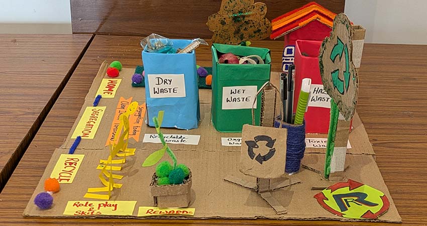 Cardboard sketch model of waste container system.