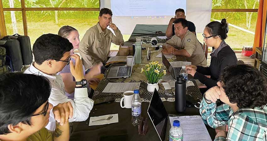 8 people around a conference table.
